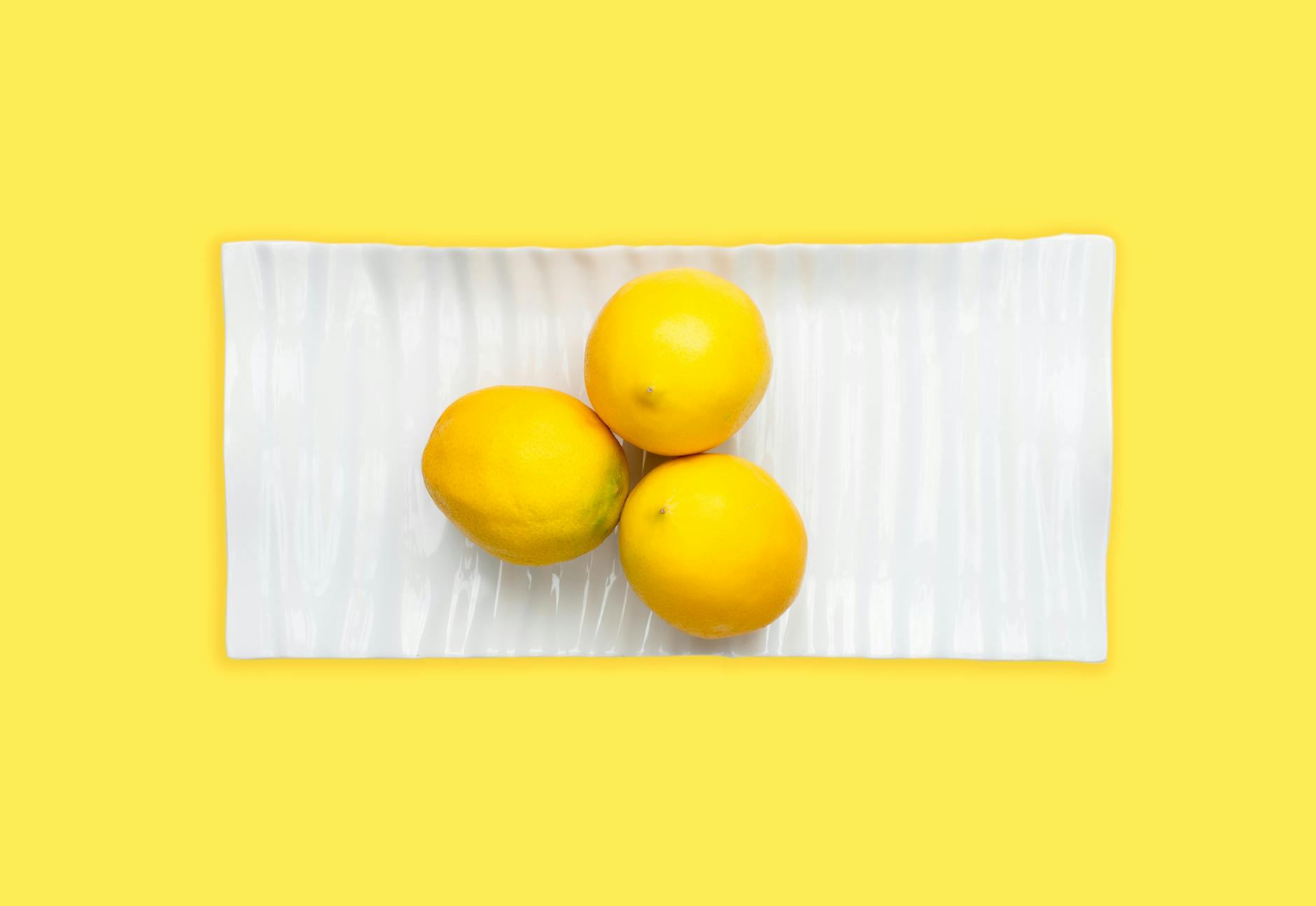 Hands holding a sleek lemon vibrator, symbolizing intimate control and self-directed pleasure