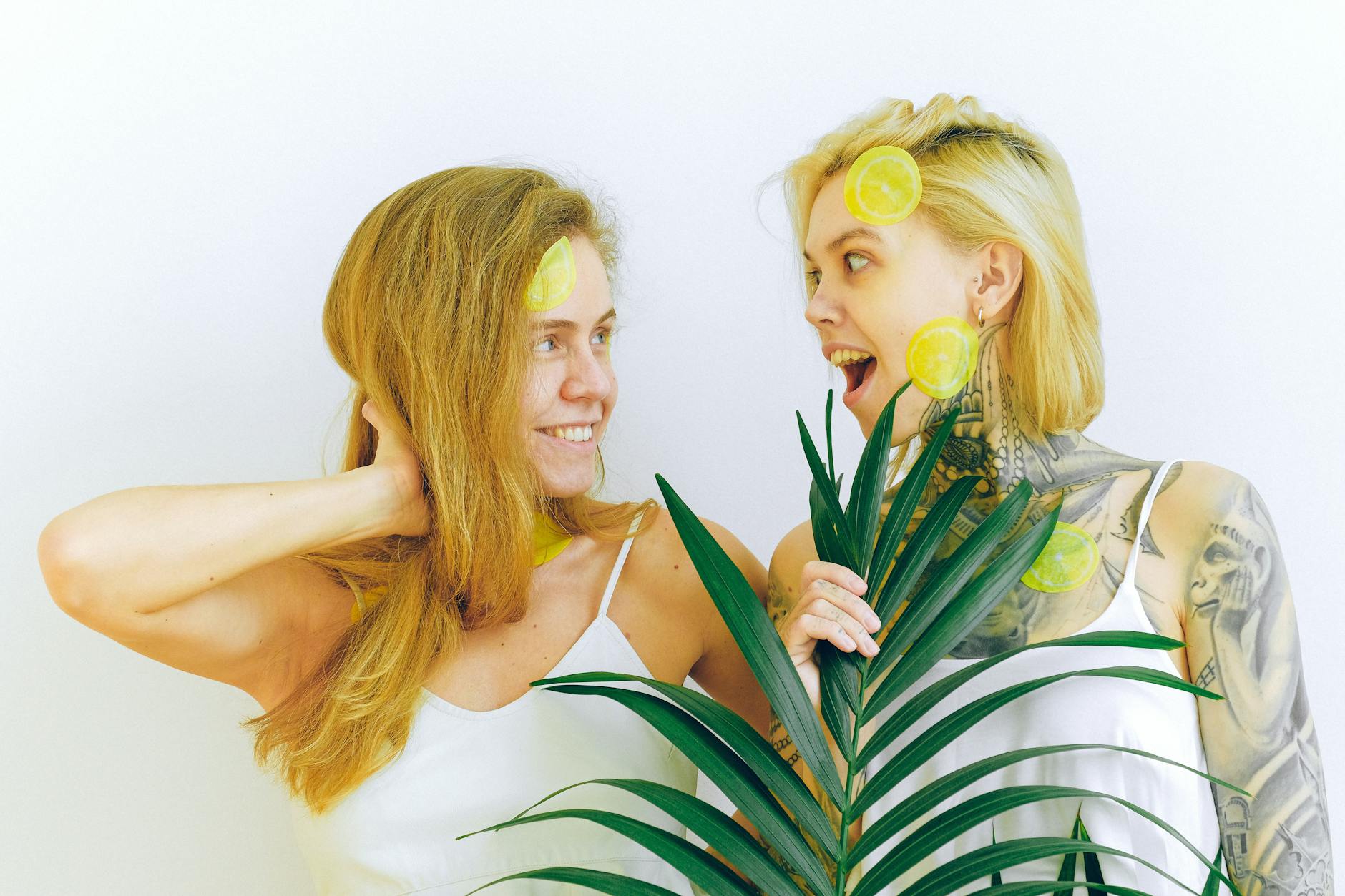 Two people smiling together with lemon slices, expressing comfort and joy in togetherness