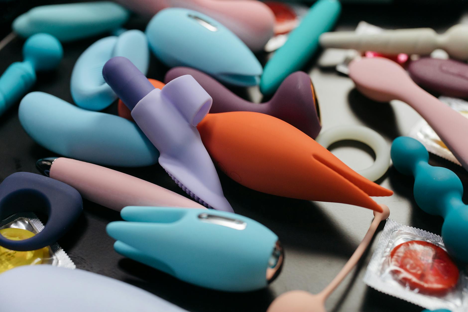 Close-up of hands holding a blue personal massager, representing tactile pleasure and intimate wellness.