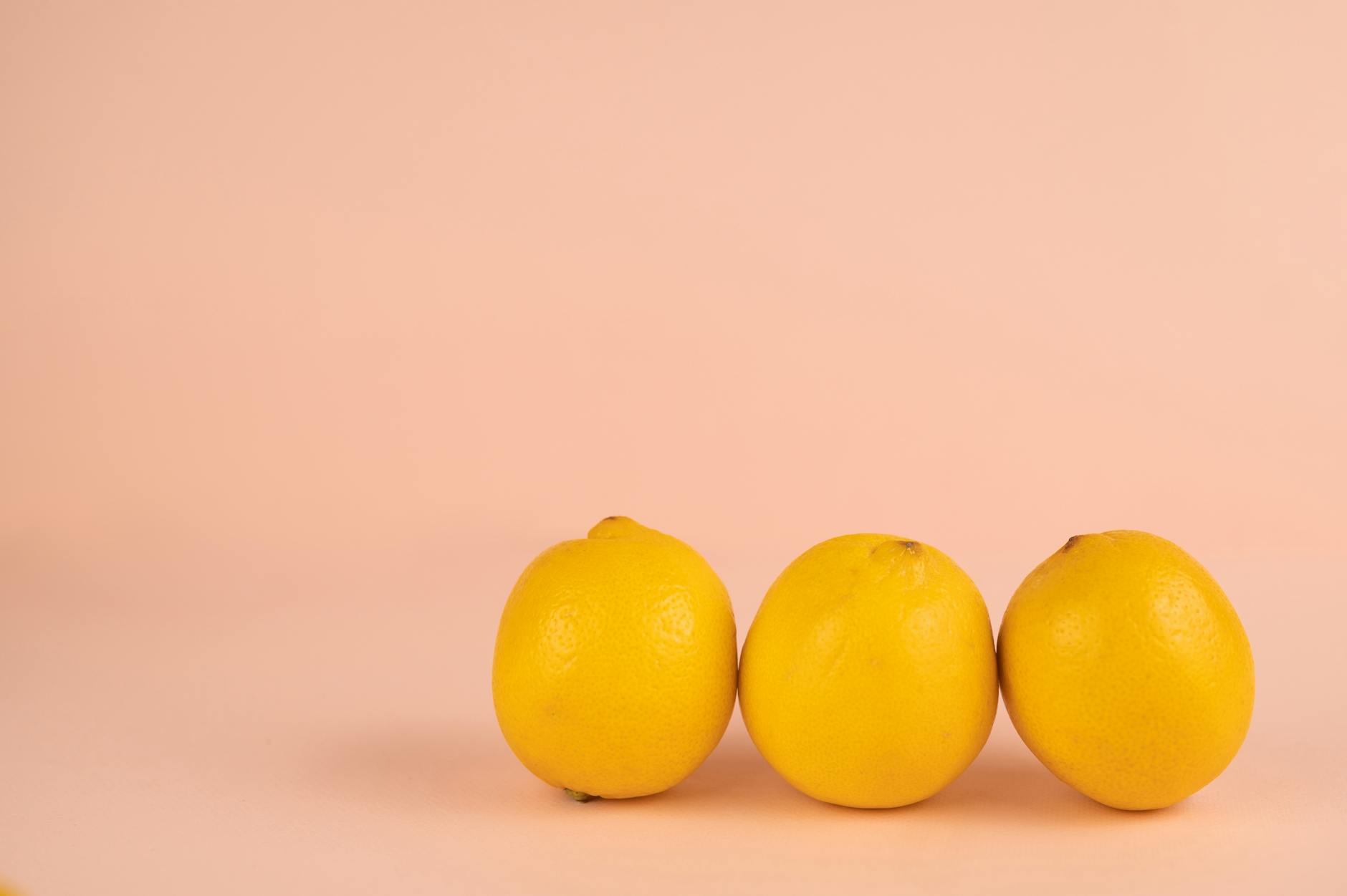 Fresh lemons arranged on a pastel background, symbolizing the brightness of pleasure with a lemon vibrator
